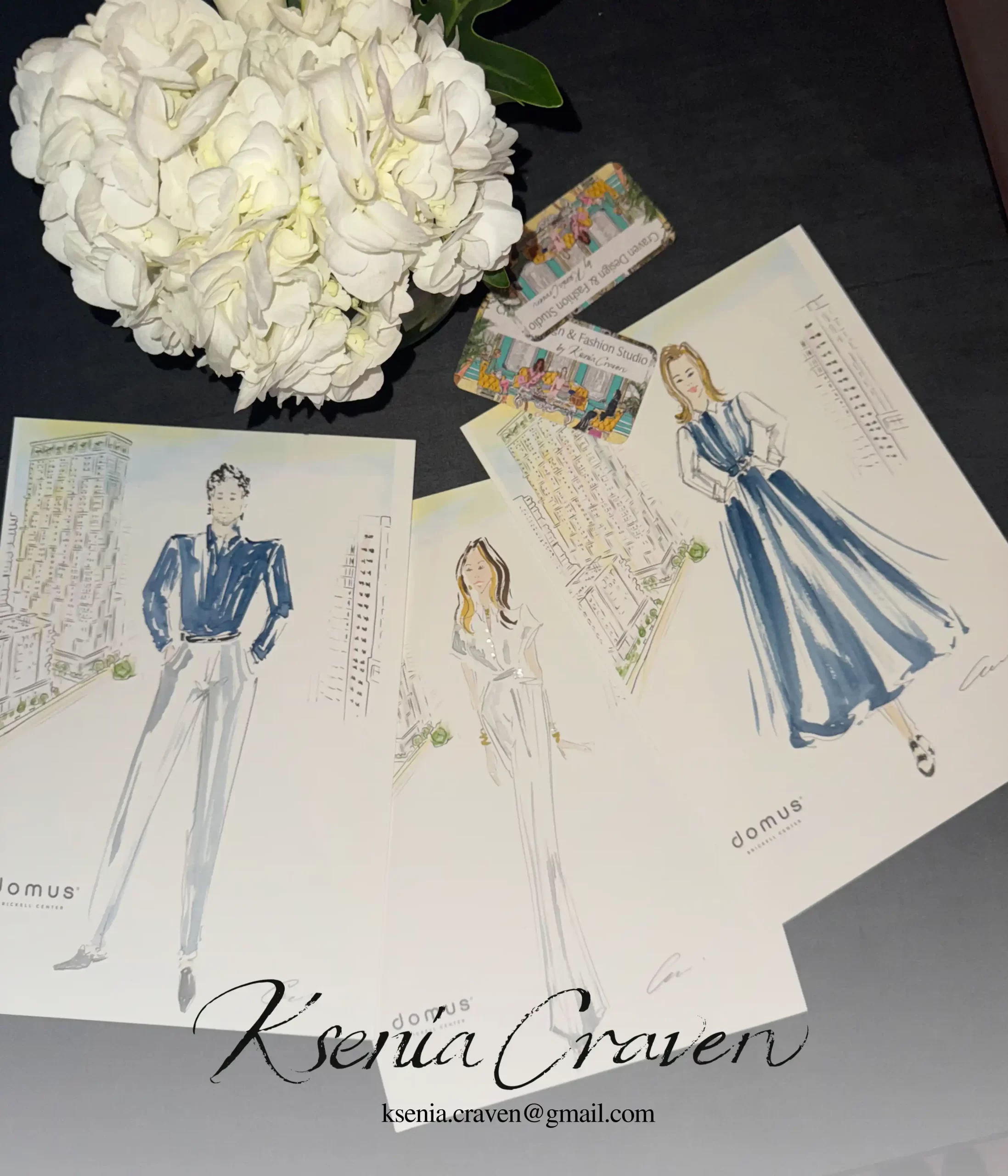 Fashion illustrator Ksenia Craven holding a custom watercolor sketch at a luxury Harry Winston event.