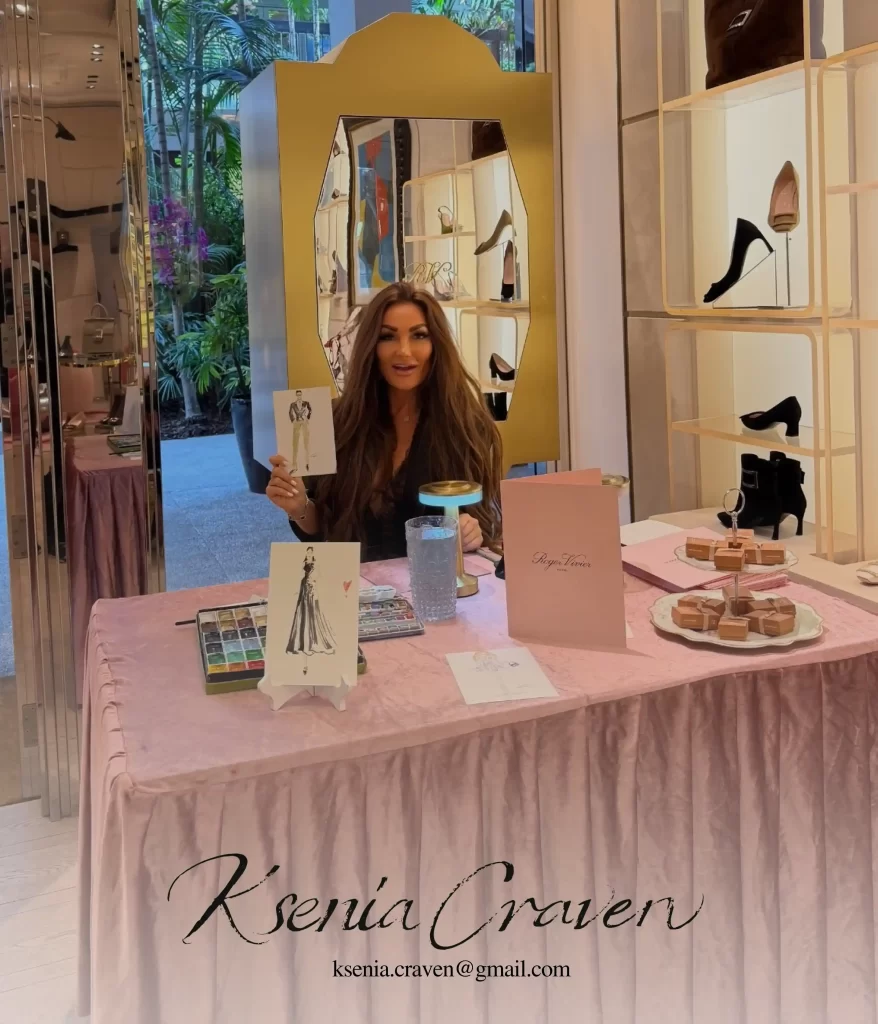 Ksenia Craven holding a watercolor fashion sketch at a live event painting station for Roger Vivier.